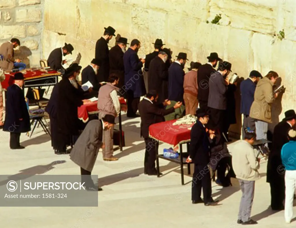 High angle view of a group of people praying in front of a stone wall, Wailing Wall, Jerusalem, Israel