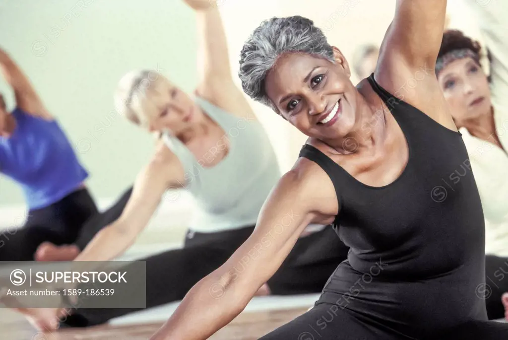 Older women stretching in yoga class