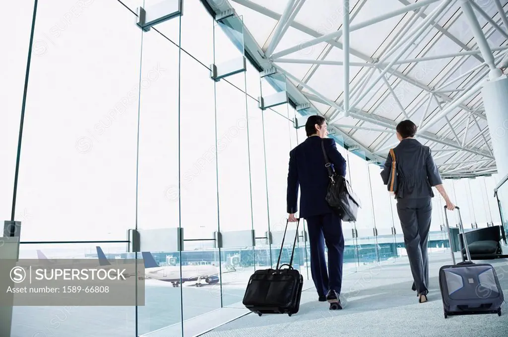 Multi_ethnic business people walking in airport