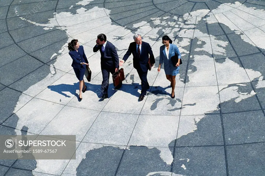 Businesspeople walking on map of globe