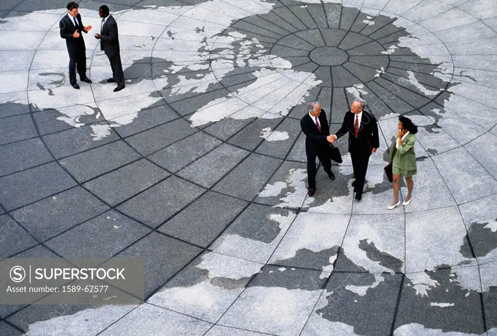 Businesspeople walking on map of globe