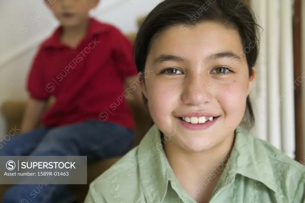 Portrait of a young girl sitting on stairs smiling