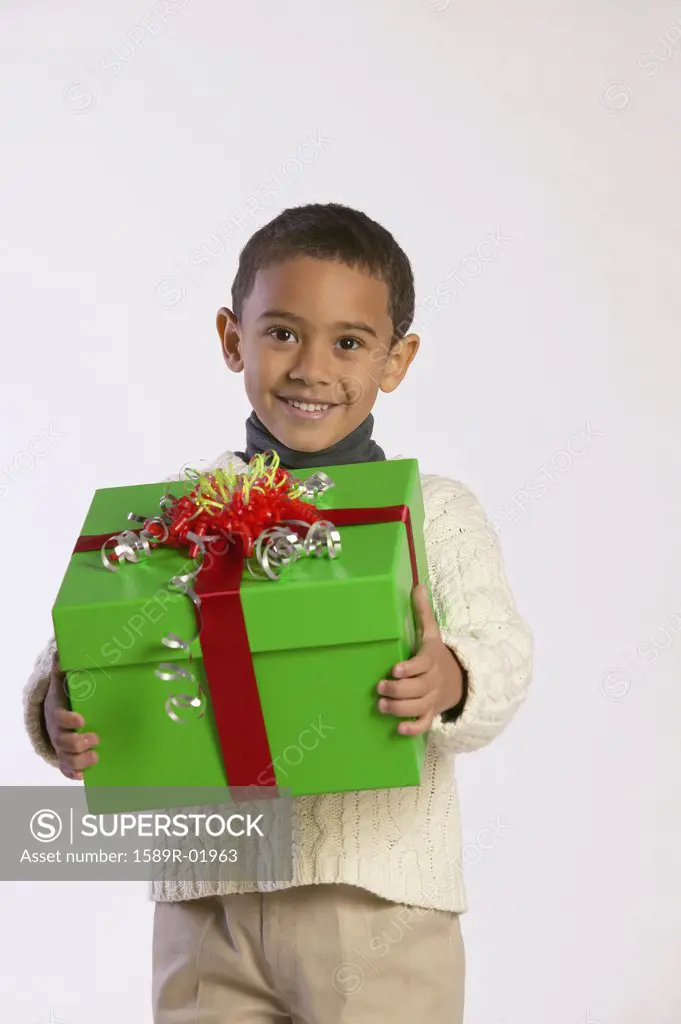 Portrait of a boy holding a gift