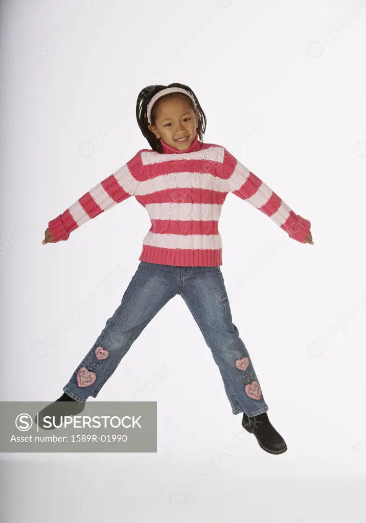 Girl jumping with her arms outstretched