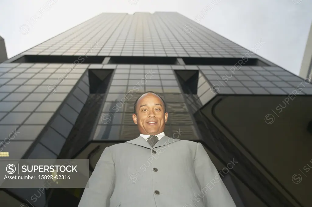 Low angle view of mid adult businessman looking at camera