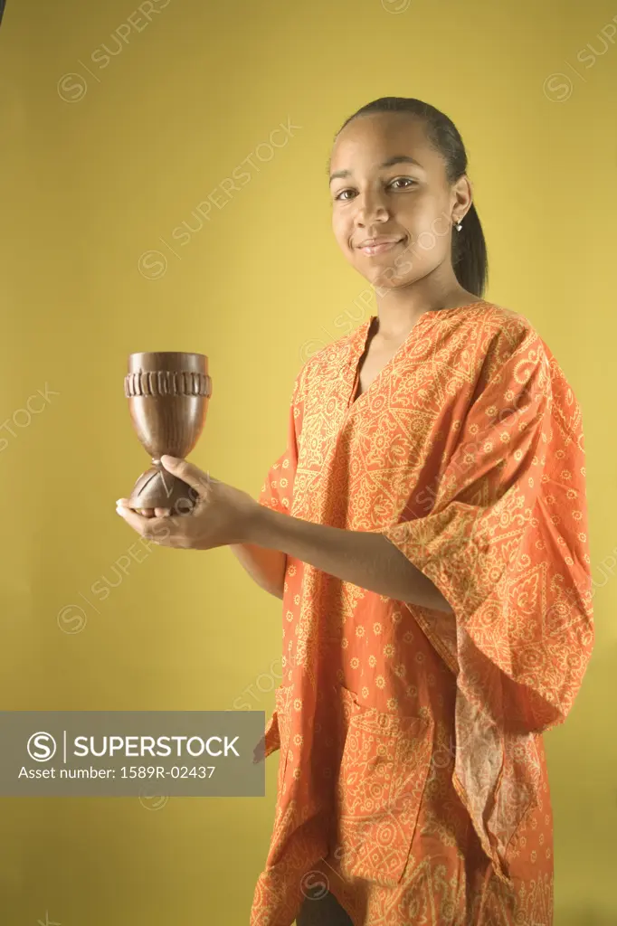 Teenage girl holding a candlestick 