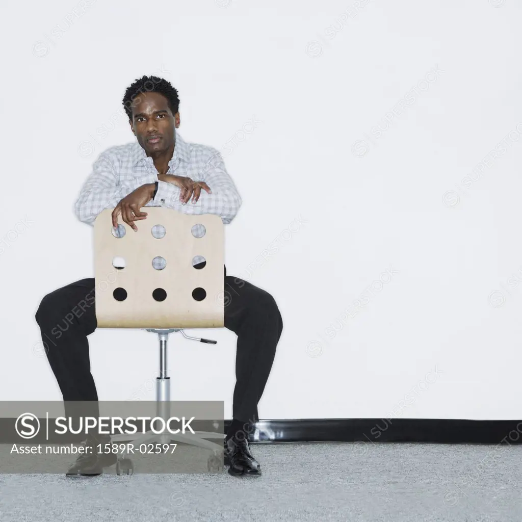 Portrait of a mid adult man sitting on a chair