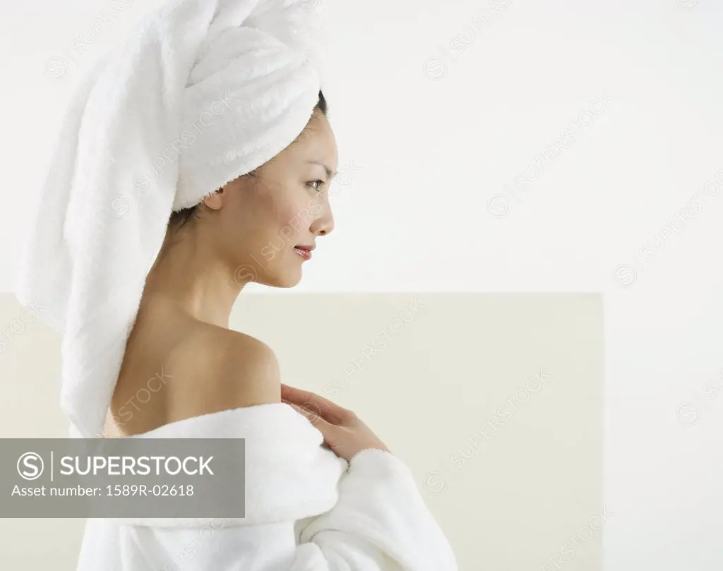 Side profile of a mid adult woman wrapped in a towel