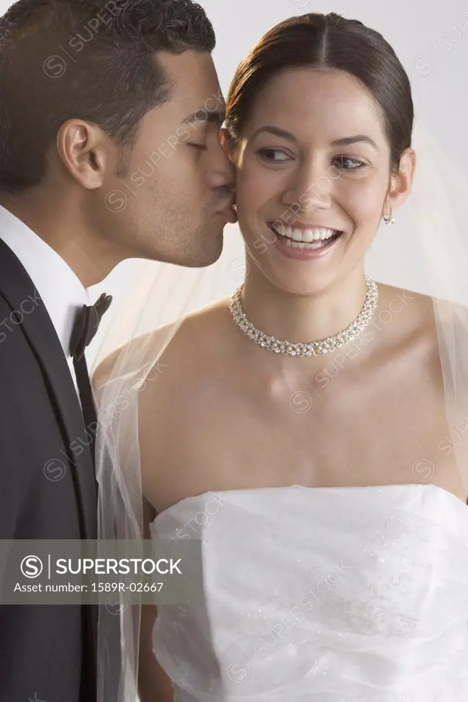 Groom kissing his bride