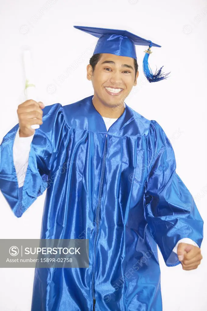Portrait of a young male graduate holding a degree