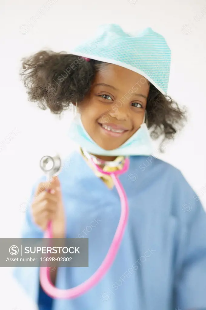 Portrait of a girl wearing medical scrubs holding a stethoscope