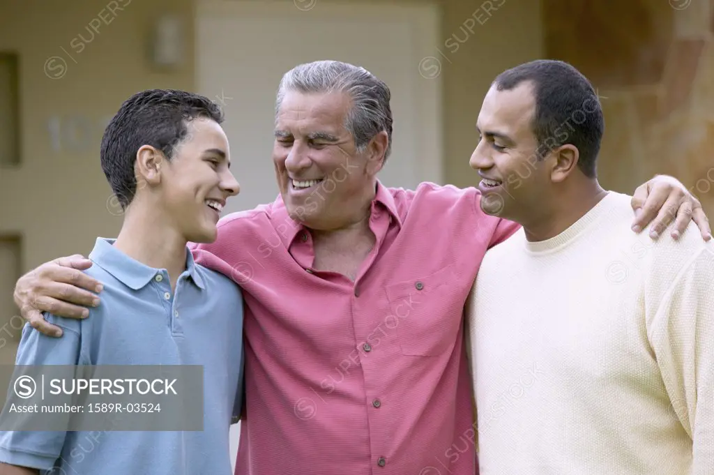 Portrait of a senior man standing with his son and grandson