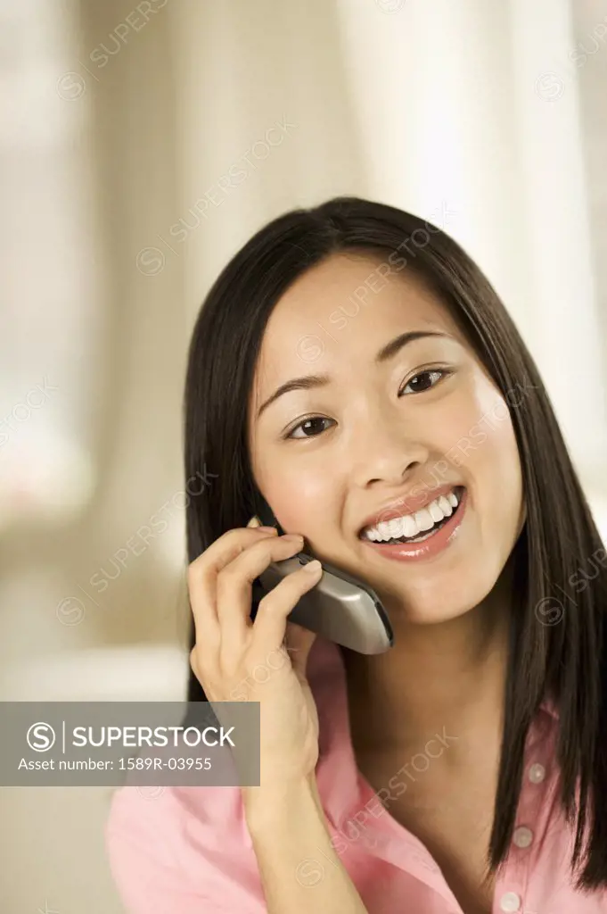 Young woman talking on a mobile phone smiling