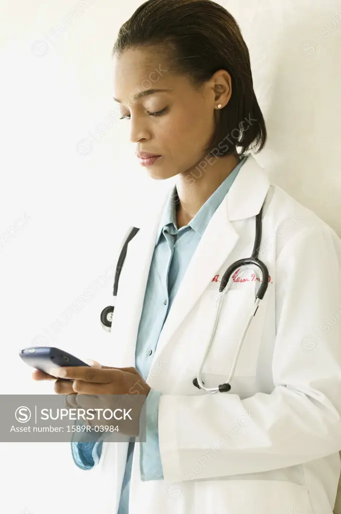 Female doctor operating a hand held device