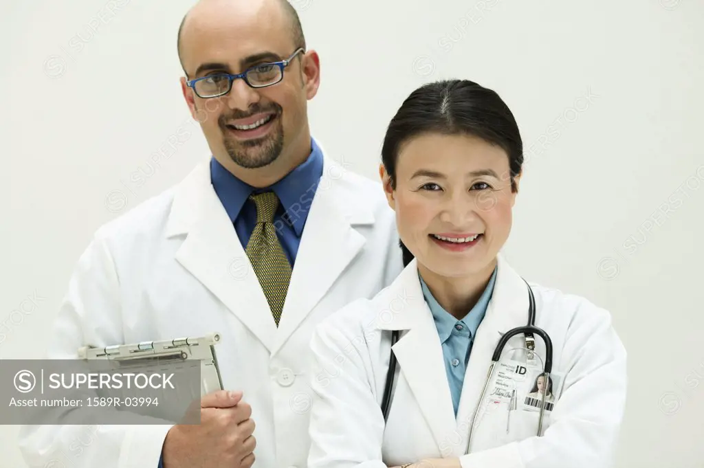 Two doctors looking at camera smiling