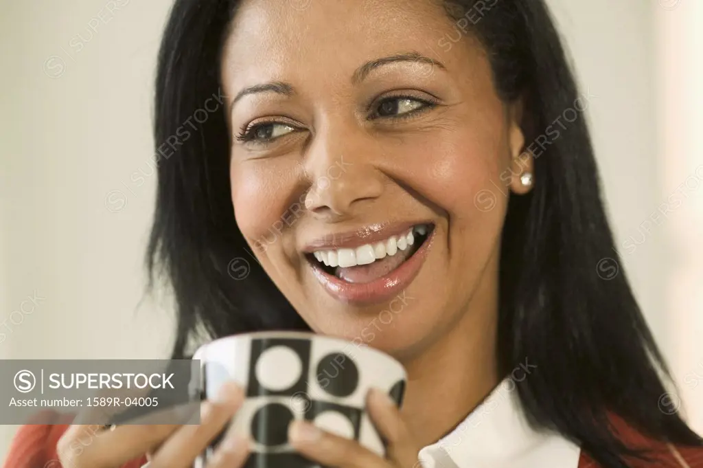 Woman holding a cup smiling