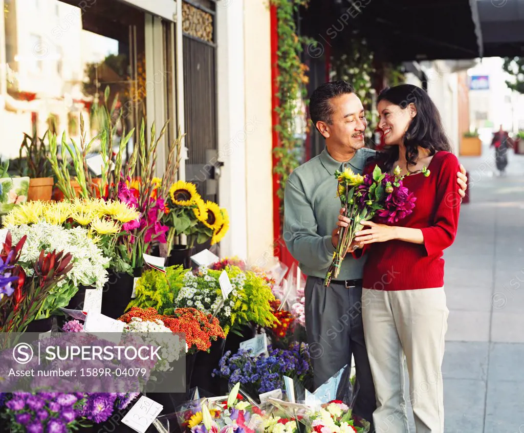 Mid adult couple standing at a flower shop