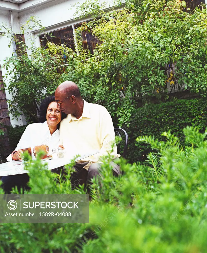 Mature couple sitting in a garden