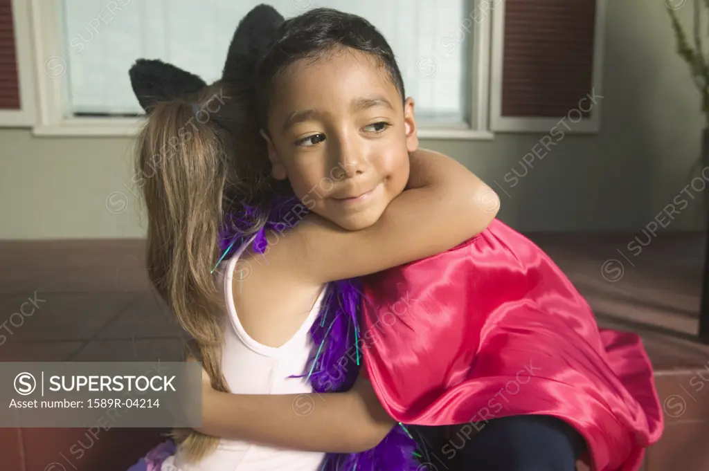 Side profile of a young boy and girl embracing