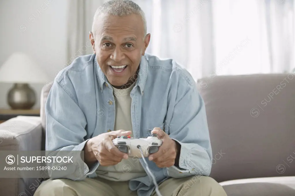 Portrait of a senior man playing a video game
