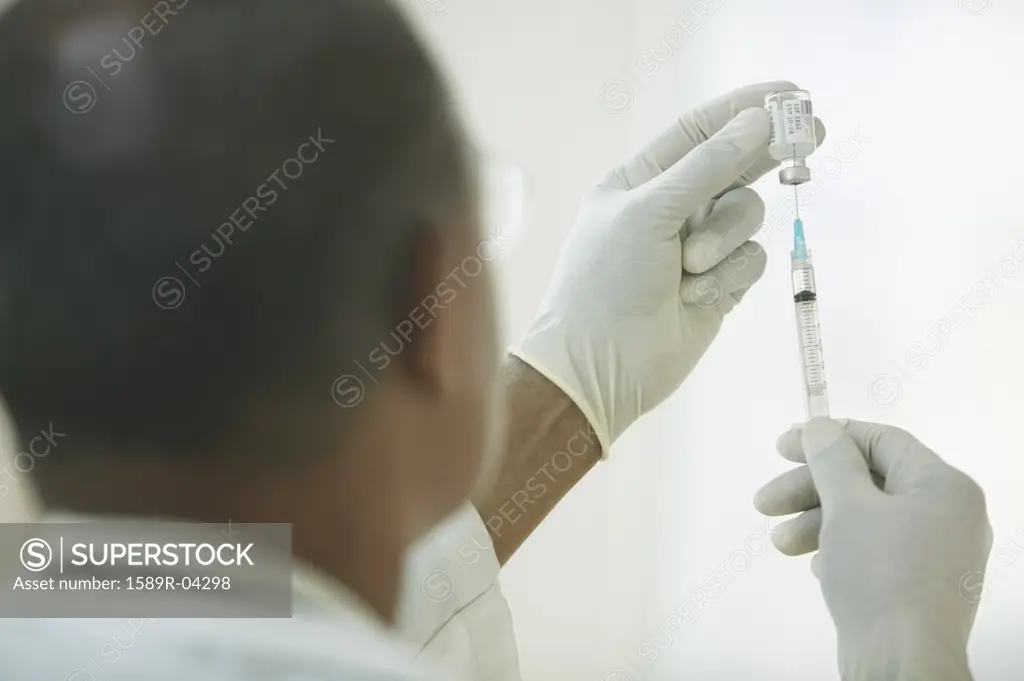 Male doctor preparing an injection