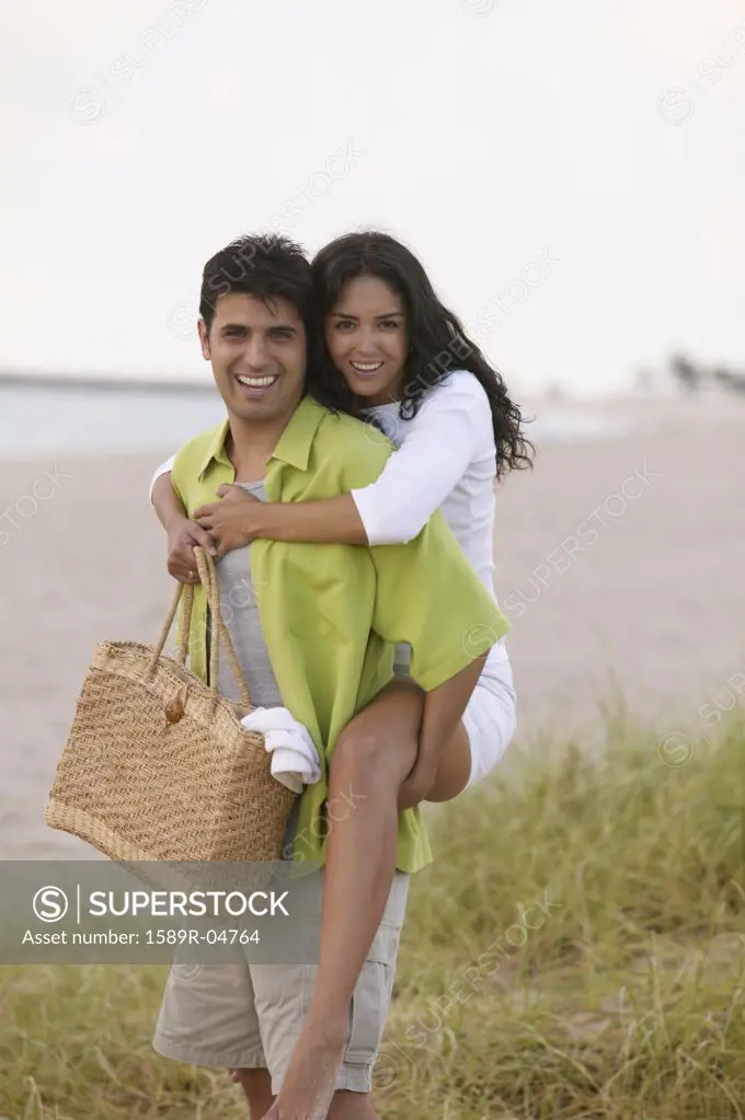 Portrait of a woman piggyback riding on a young man