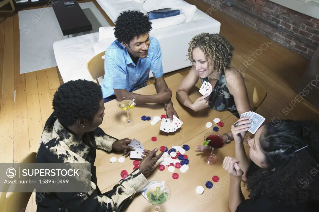 Group of people sitting at a table playing poker