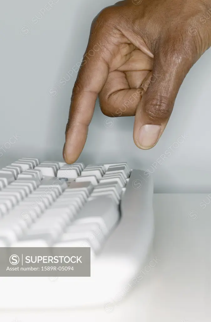 Human hand operating a computer keyboard,