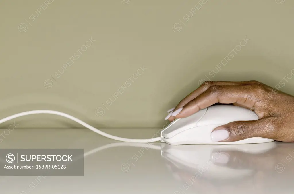 Woman's hand operating a computer mouse