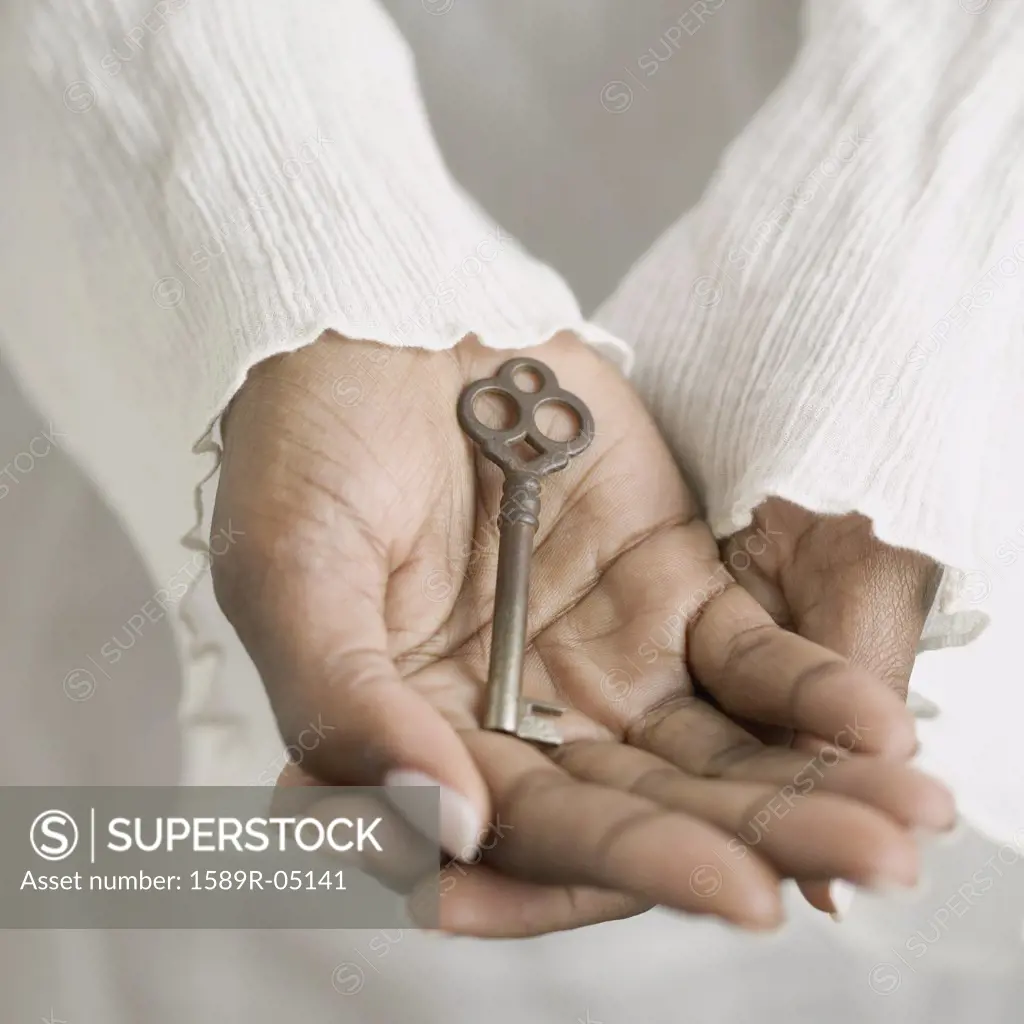 Woman's hands holding a key