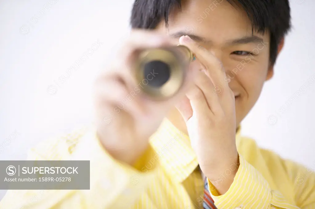 Businessman looking through a telescope smiling