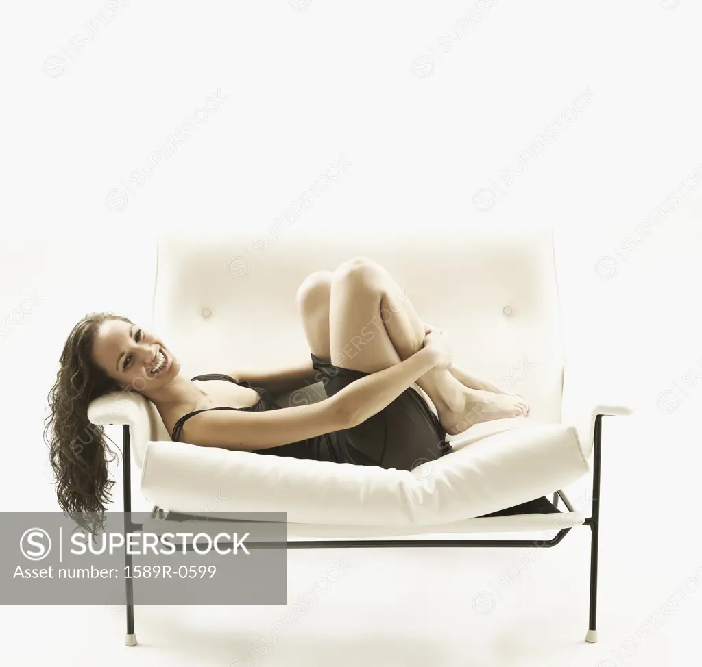 Portrait of young woman lying on a couch