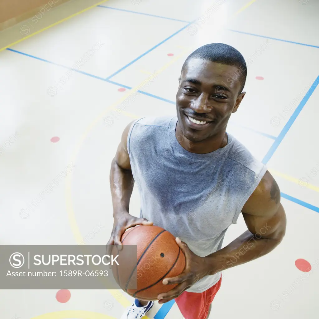 High angle view of a young man holding a basketball