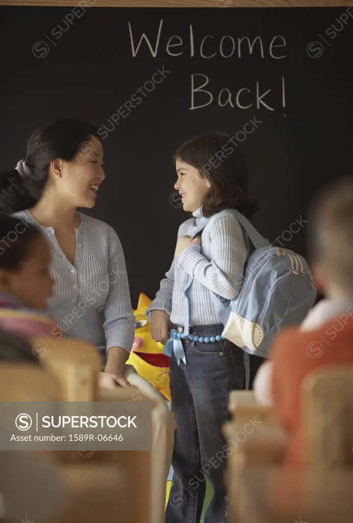 Female teacher talking to her students in a classroom