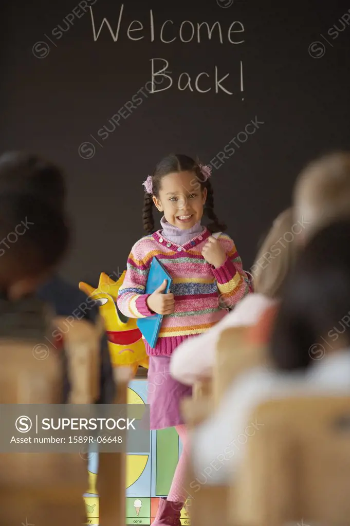 Girl standing in front of a class