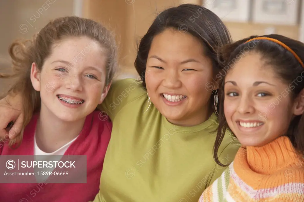 Portrait of three teenage girls smiling
