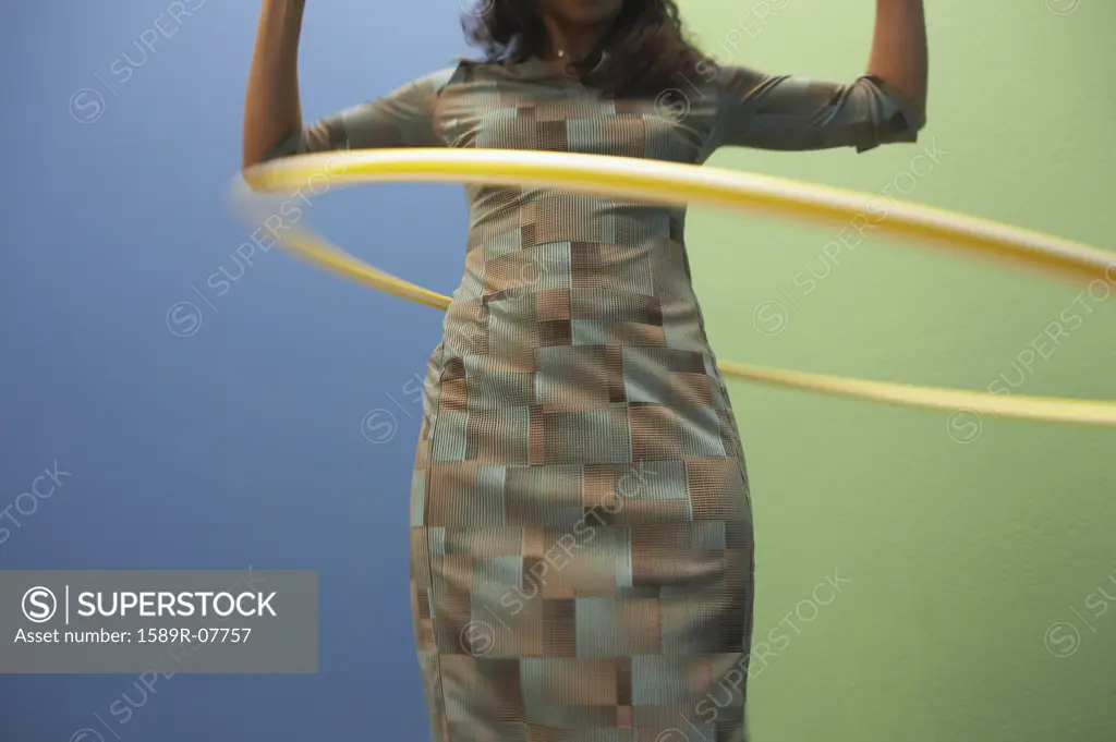 Mid adult woman playing with a hula hoop