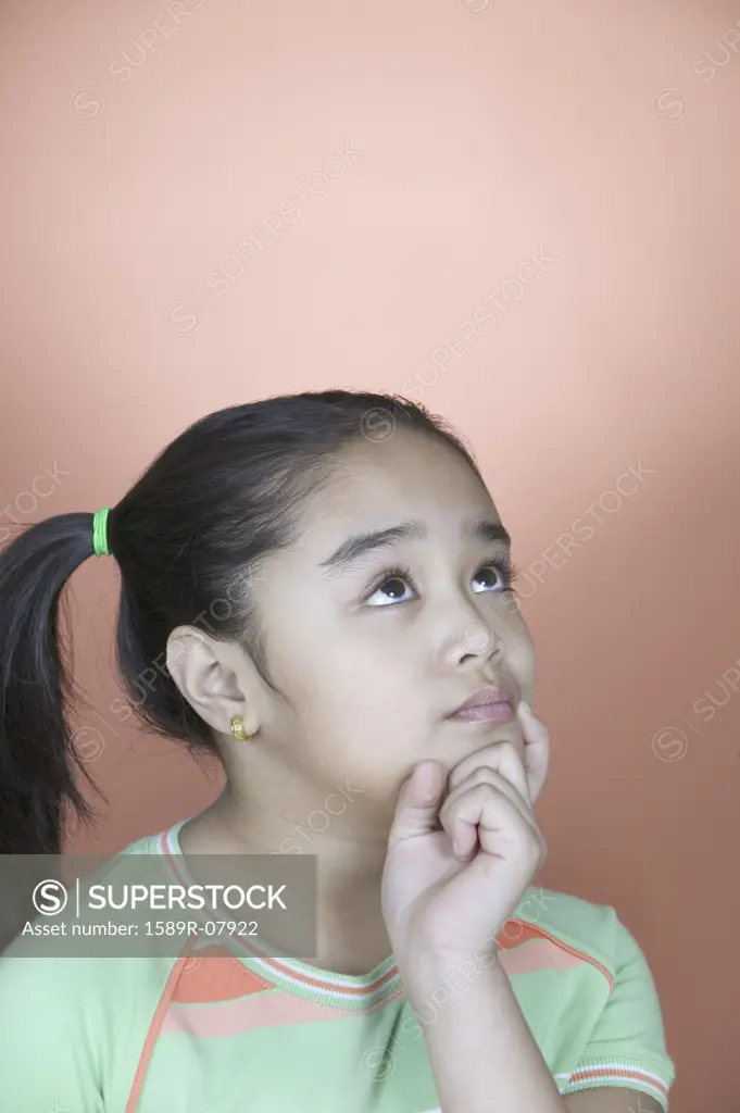 Close-up of a girl thinking with her hand on her chin