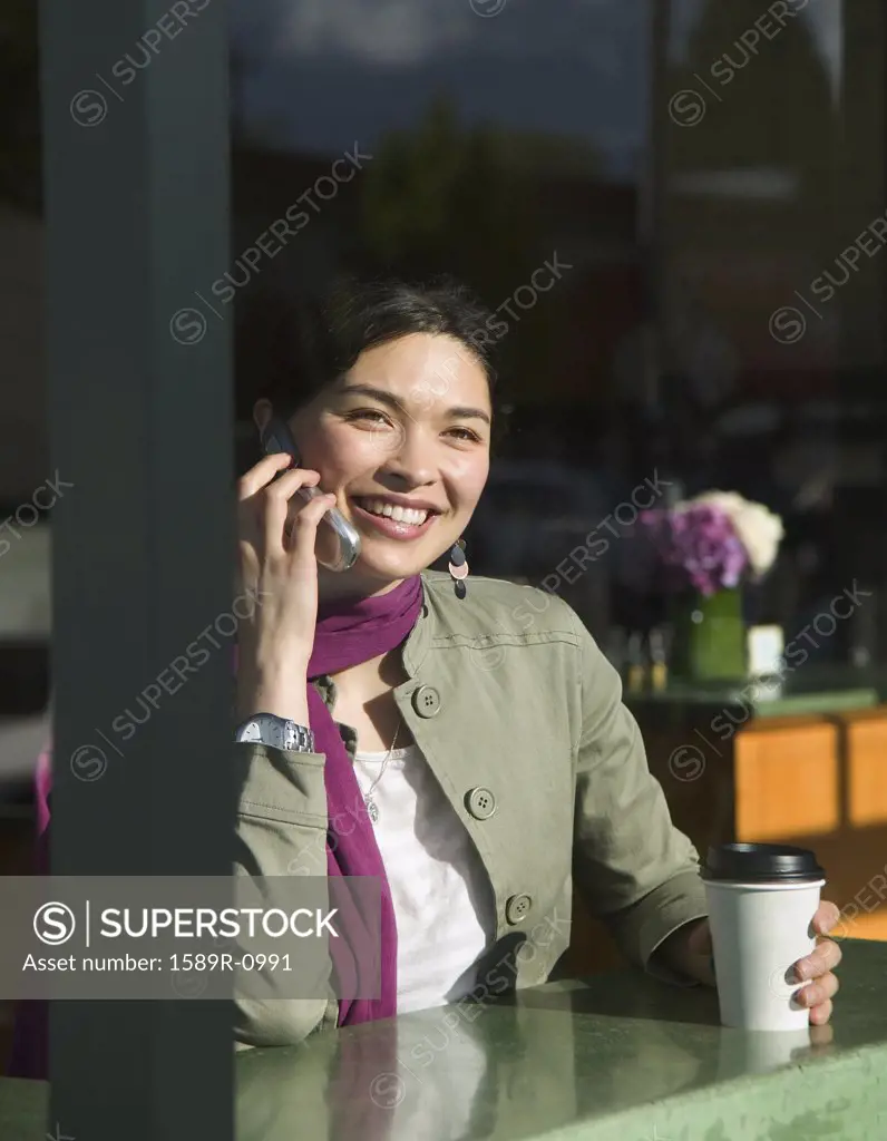 Young woman smiling talking on a mobile phone