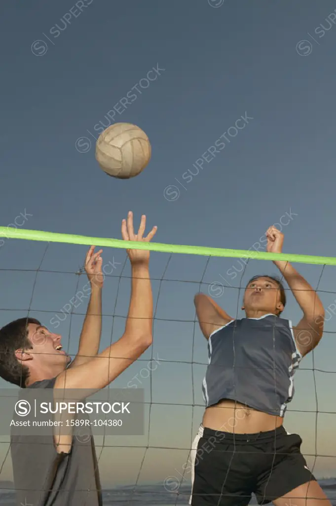 Young couple playing volleyball