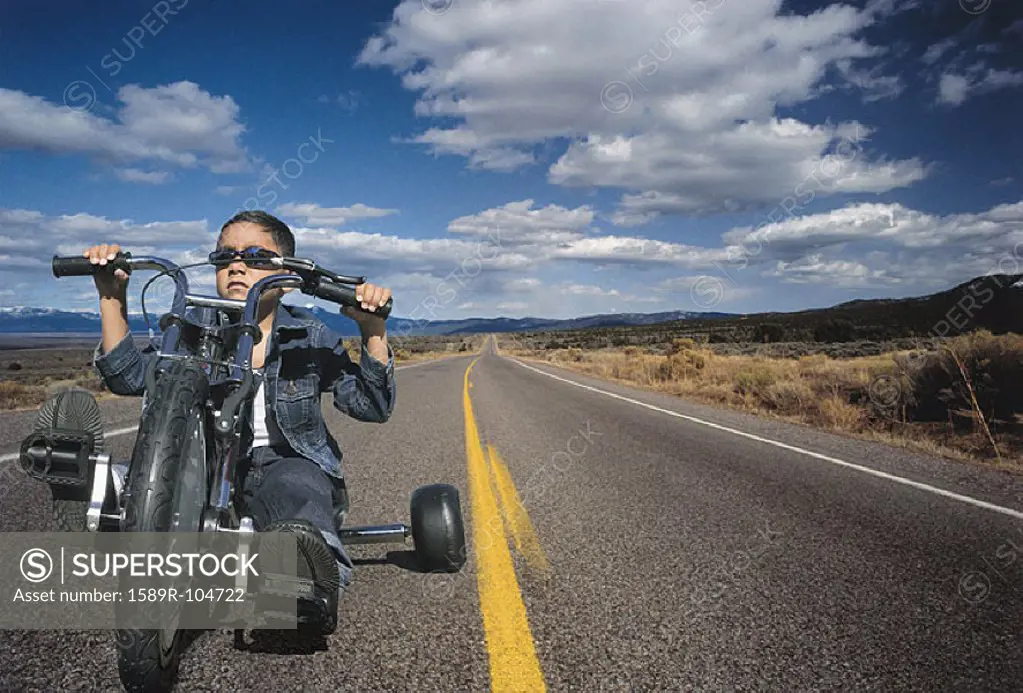 Young boy on toy motorcycle