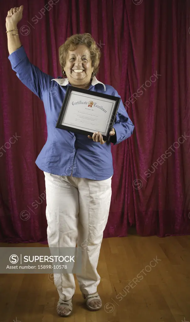 Woman holding certificate triumphantly