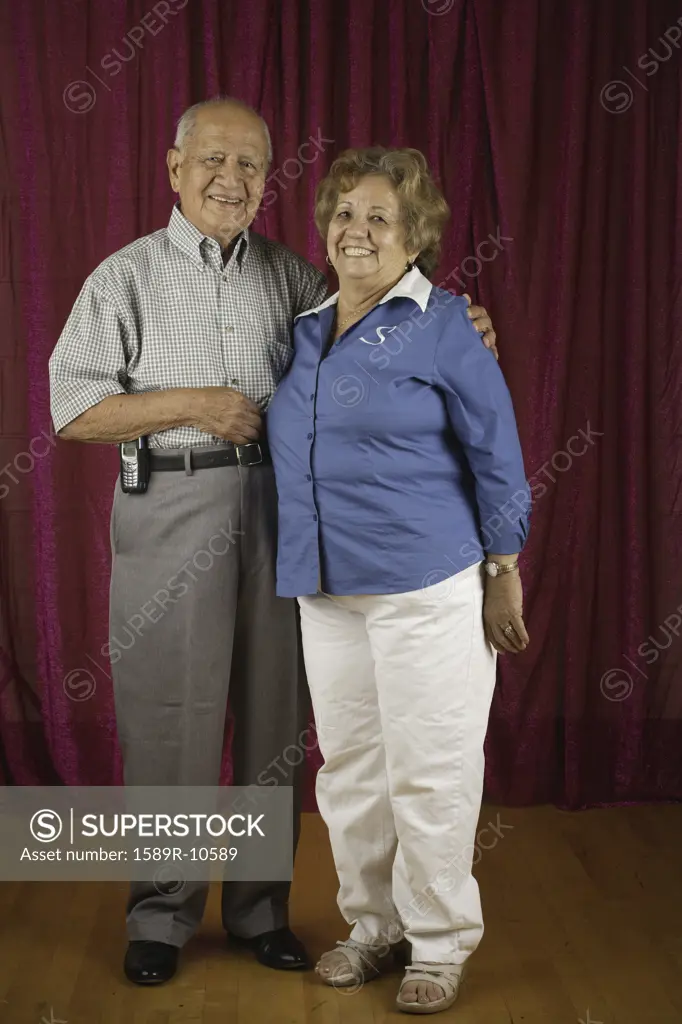 Elderly couple smiling at camera