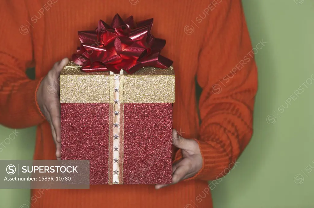 Close-up view of man holding a gift