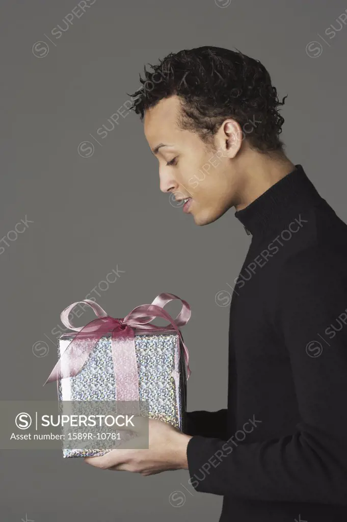 Young man holding a gift