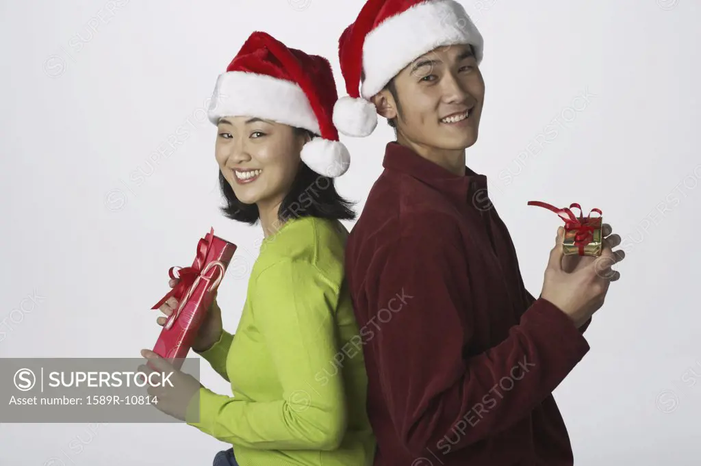 Portrait of young couple with gifts