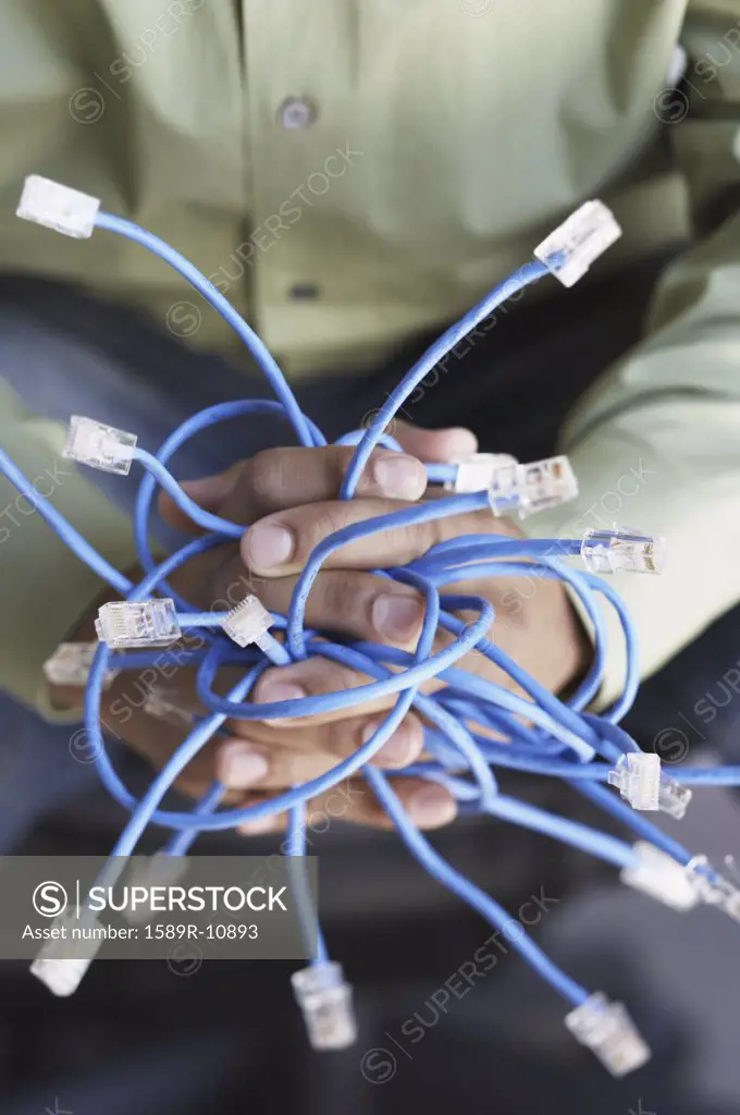 Closeup of hands holding Ethernet cables
