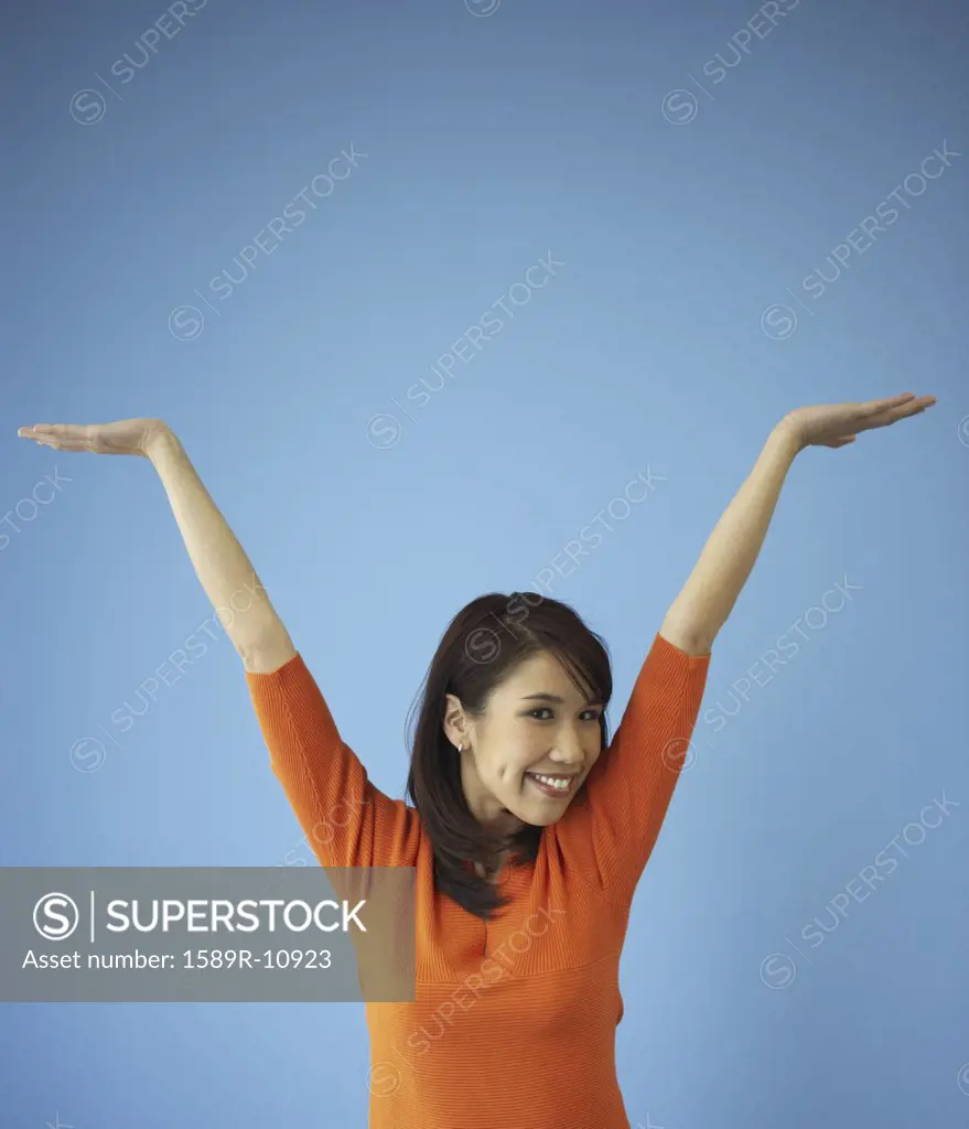 Young woman with arms raised