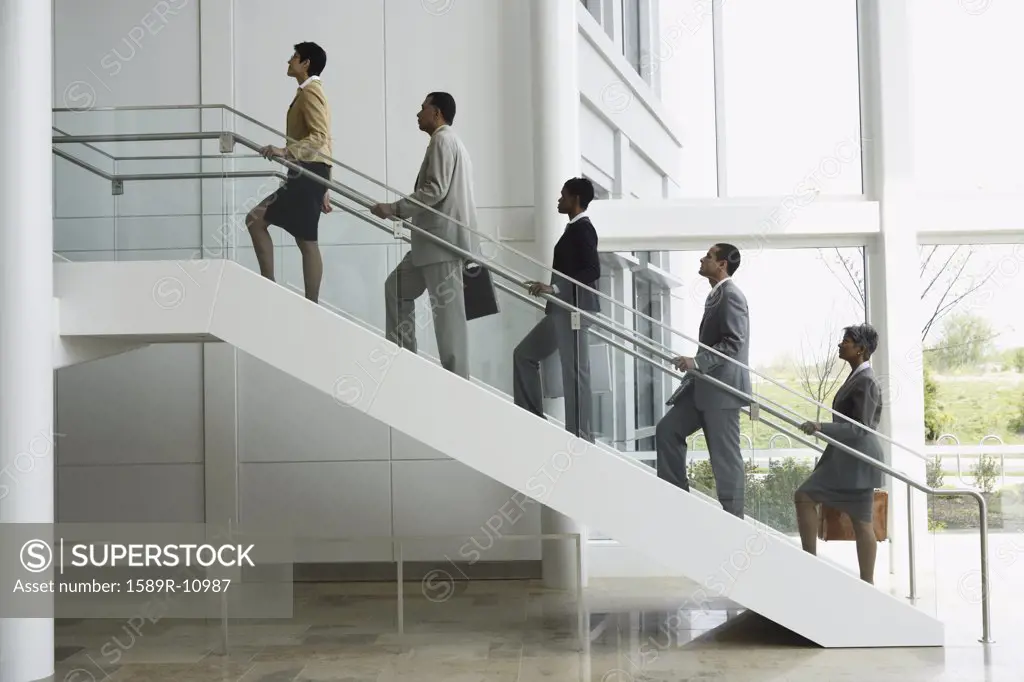 Group of business people climbing stairs