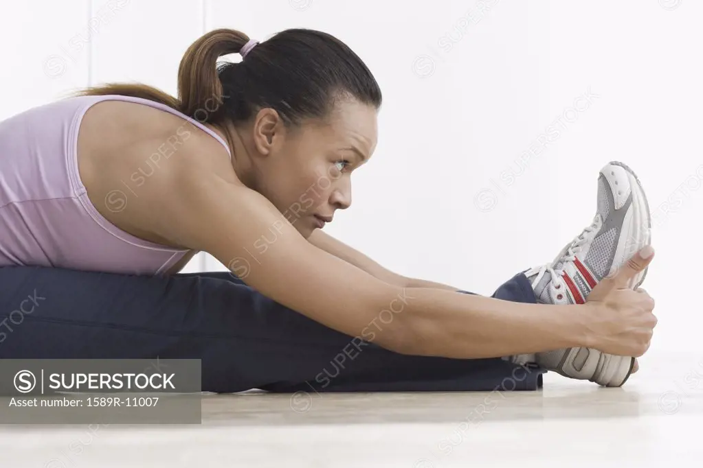 Side view of woman stretching